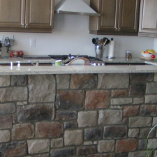 For a rustic looking kitchen, choose a rustic looking stone veneer.